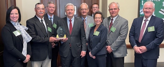 A group of Farm Credit directors and employees present Sen. Hoeven with the Friend of Farm Credit Award