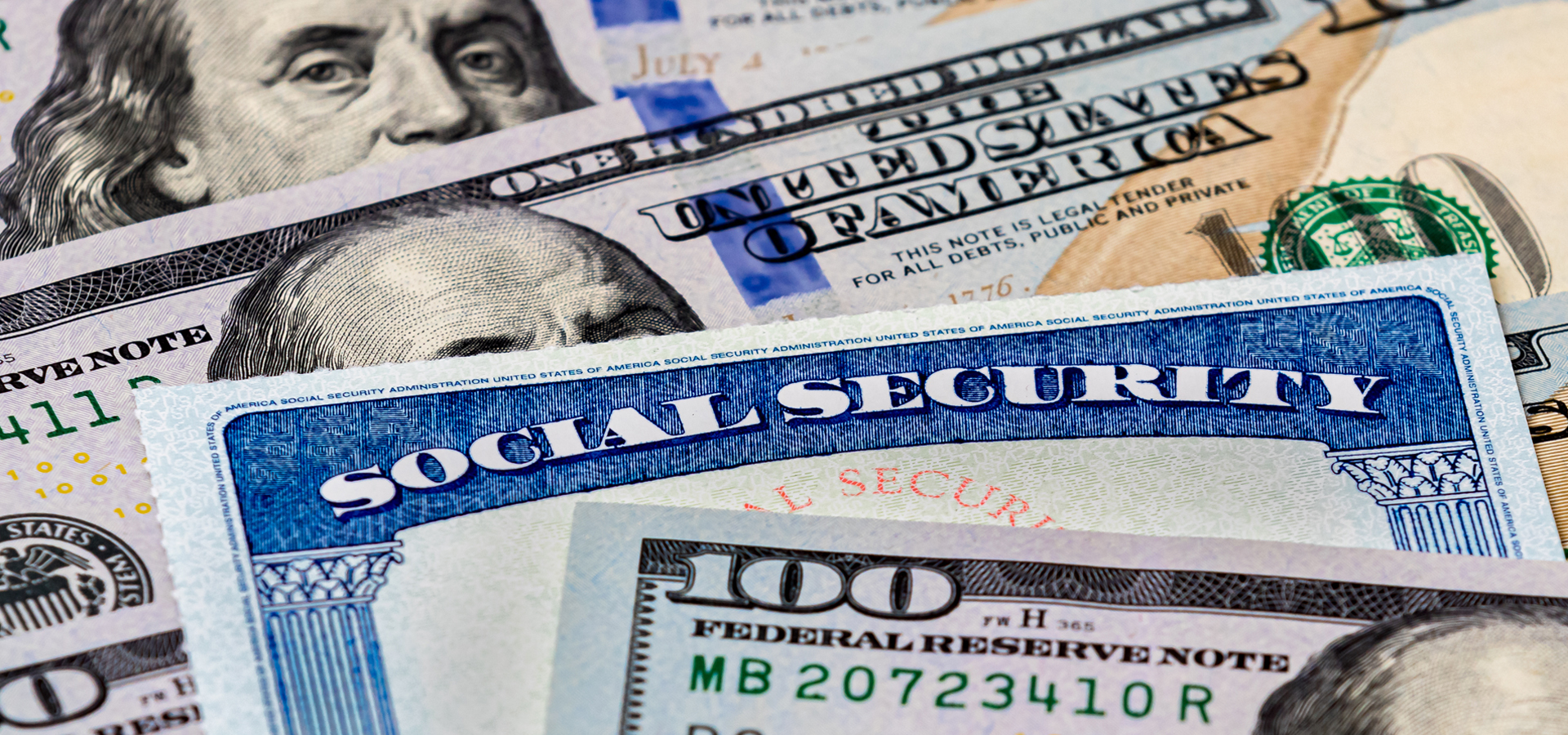 A Social Security card in between Dollar bills