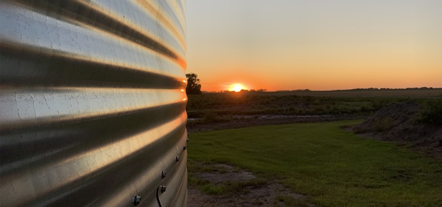 Sunset next to a grain bin